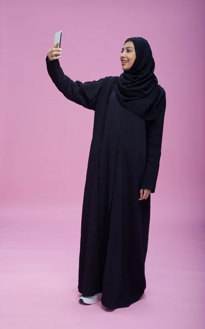 Saudi Woman in Abaya Taking Smartphone Selfie