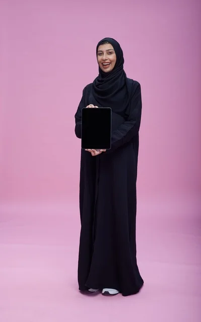 Saudi Woman Holding Blank Tablet on Pink Background