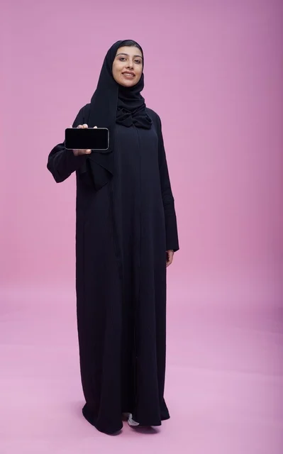 Saudi Woman in Abaya Holding Smartphone with Blank Screen