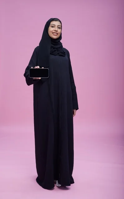 Saudi Woman in Abaya Holding Smartphone with Blank Screen