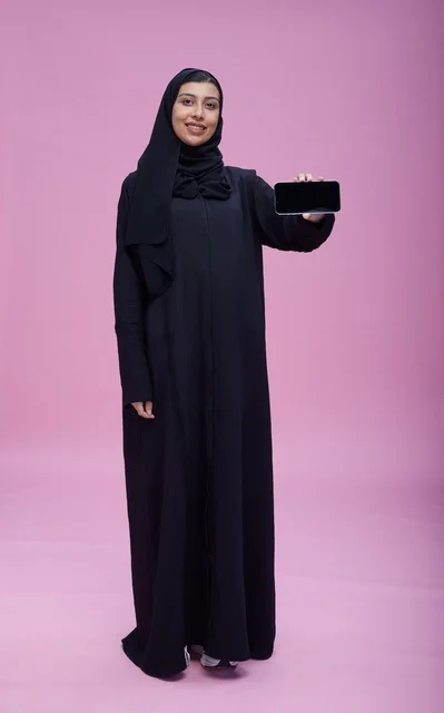 Saudi Woman in Abaya Holding Phone Mockup Pink Studio
