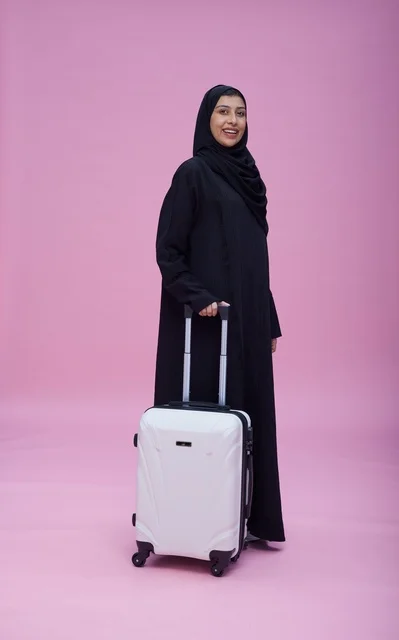 Saudi Woman in Abaya with Travel Suitcase