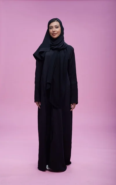 Saudi Woman in Black Abaya on Pink Background