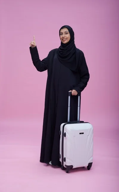 Saudi Woman with Suitcase on Pink Background