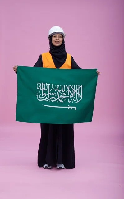 Saudi Female Engineer Holding National Flag in Studio