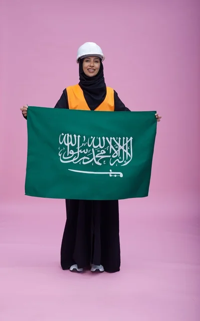 Saudi Female Engineer Holding National Flag in Studio