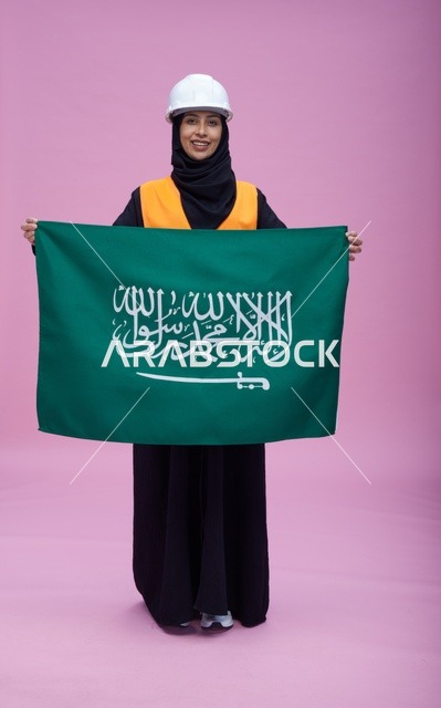 Saudi Female Engineer Holding Saudi Flag in Studio