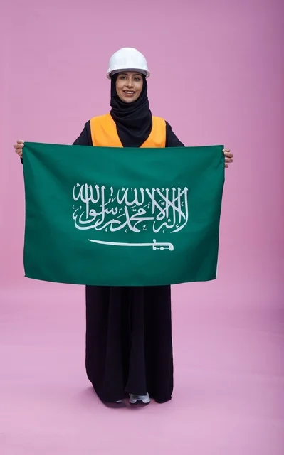 Saudi Female Engineer Holding Saudi Flag in Studio