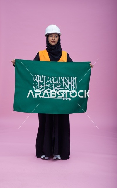 Saudi Female Engineer Holding Saudi Flag on Pink Background