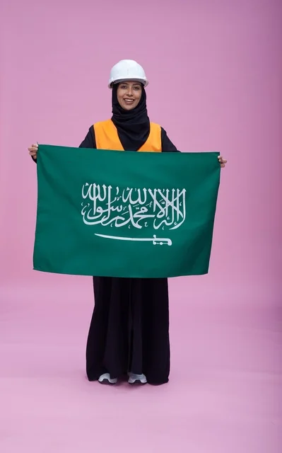 Saudi Female Engineer Holding National Flag in Studio