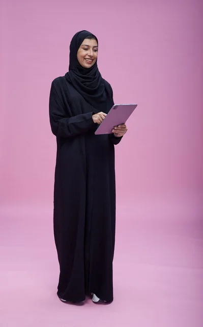 Saudi Woman Using Digital Tablet in Studio Setting