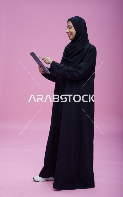 Saudi Woman Using Digital Tablet in Studio