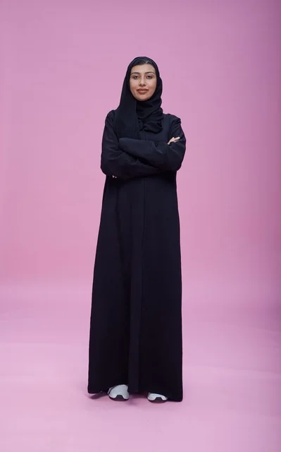 Saudi Woman in Abaya with Crossed Arms Pink Studio