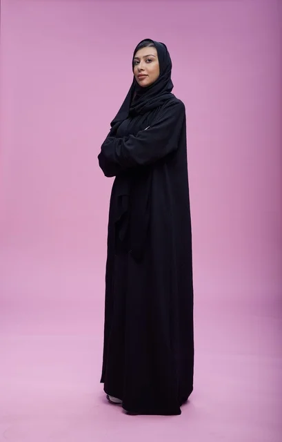 Saudi Woman in Black Abaya on Pink Background