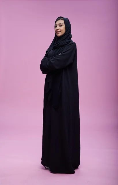 Saudi Woman in Black Abaya on Pink Background
