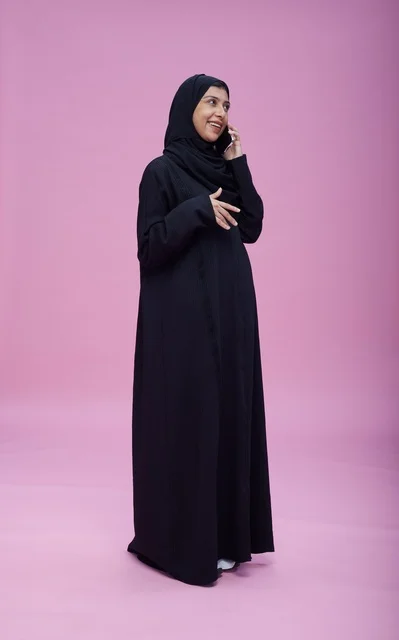 Saudi Woman in Black Abaya Talking on Smartphone