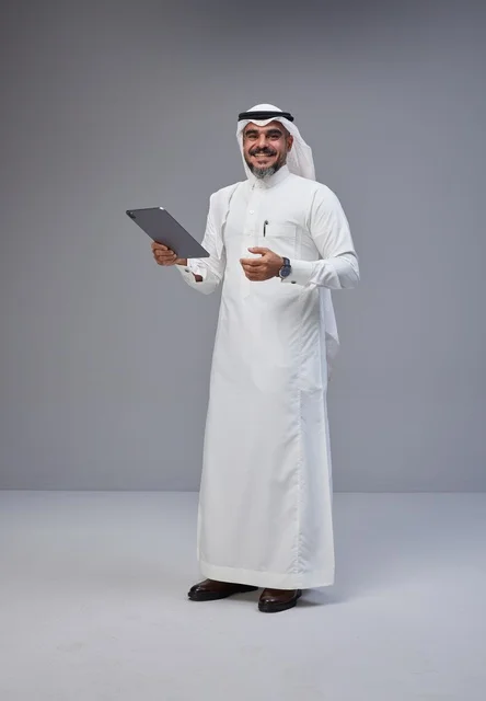 Saudi Man in Traditional Thobe Holding Digital Tablet