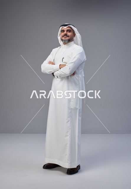Saudi Man in Traditional Thobe with Crossed Arms
