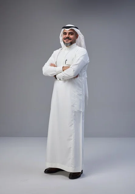 رجل سعودي بالزي التقليدي يقف بثقة في استوديو