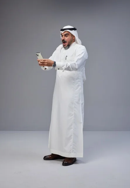 Saudi Man Shocked Looking at Smartphone in Studio