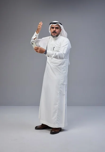 Angry Saudi Man in Traditional Thobe with Smartphone