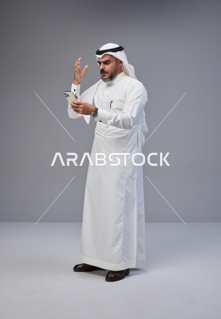 Saudi Man Frustrated Using Smartphone in Studio