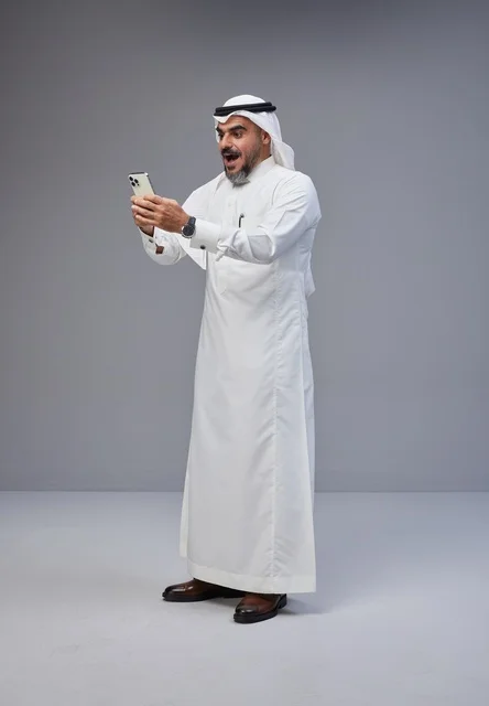 Surprised Saudi Man Using Smartphone in Studio