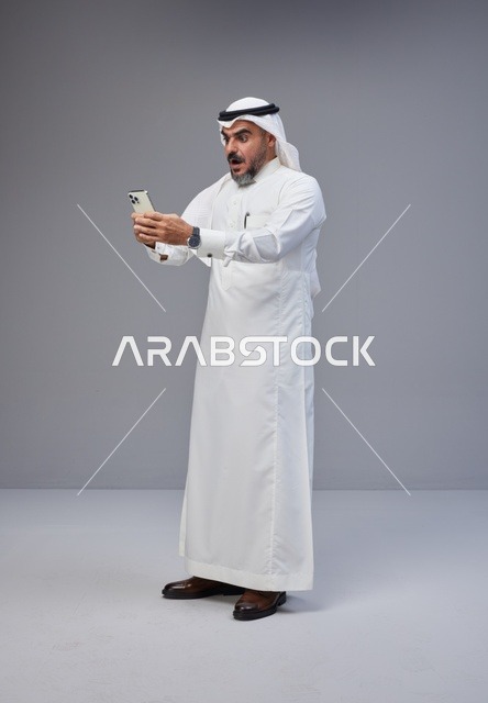 Surprised Saudi Man Using Smartphone in Studio