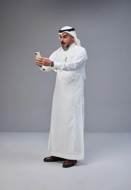Surprised Saudi Man Using Smartphone in Studio