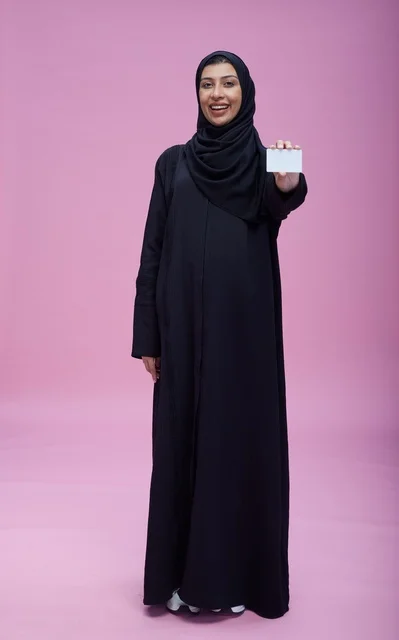 Saudi Woman Holding Blank Card on Pink Background