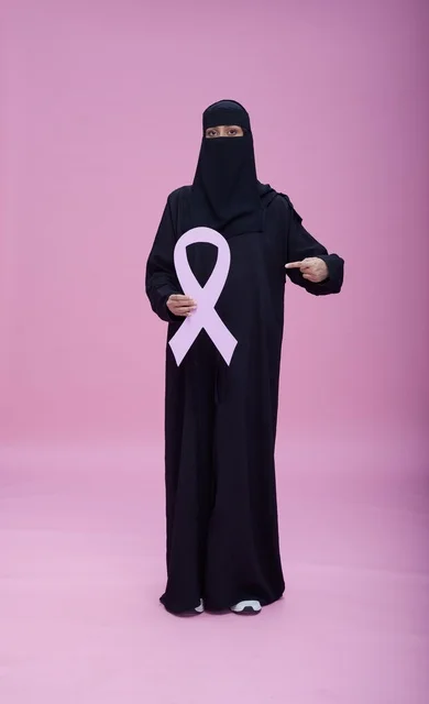 Saudi Woman in Niqab Holding Breast Cancer Ribbon