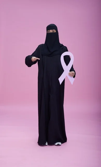 Saudi Woman in Niqab Holding Breast Cancer Ribbon