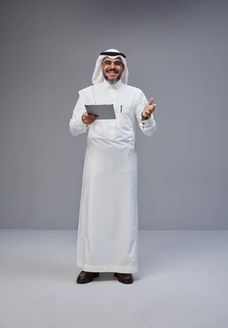 Saudi Man in Traditional Thobe Using Digital Tablet
