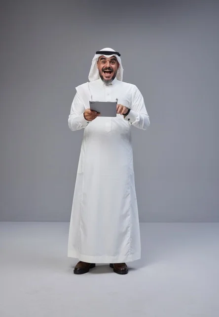 Excited Saudi Man Using Tablet in Studio