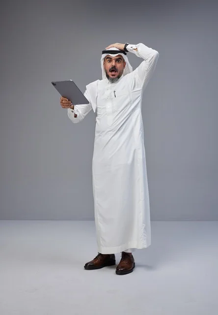 Shocked Saudi Man Holding Tablet in Studio