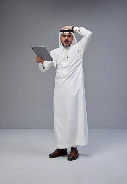 Shocked Saudi Man in Traditional Dress with Tablet