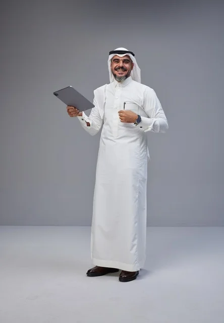 Saudi Man in Traditional Thobe Holding Digital Tablet