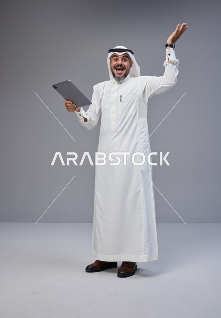 Excited Saudi Man Holding Tablet Success Celebration