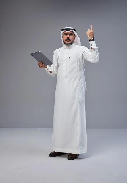 Saudi Man in Traditional Thobe Holding Tablet Studio