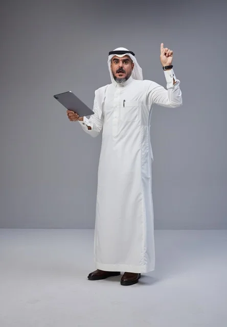 Saudi Man with Tablet Pointing Up in Studio