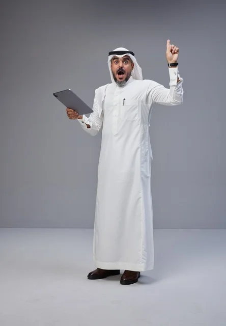 Saudi Arabic Man with Tablet Pointing Upwards in Studio