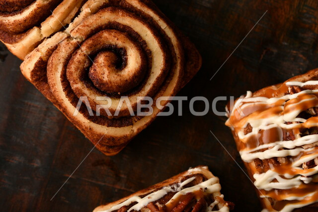 Close-up of delicious cinnamon rolls, cinnabon rolls, pastries, fresh baked goods, delicious dessert rolls