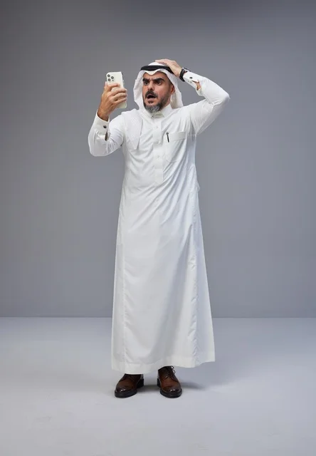 Saudi Man in Thobe Reacting to Smartphone Shock