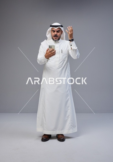 Saudi Man in Traditional Thobe Angry at Smartphone
