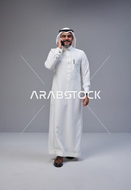 رجل سعودي بالزي التقليدي يتحدث عبر الهاتف