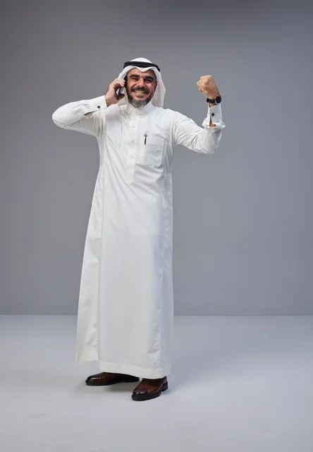 Saudi Man in Traditional Thobe Celebrating on Phone