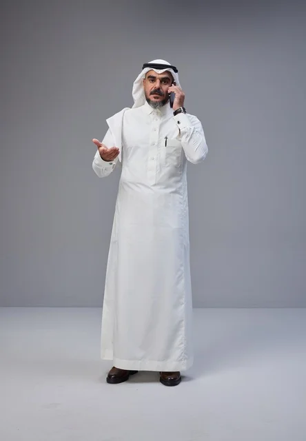 Saudi Man in Traditional Thobe Talking on Phone Studio