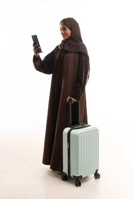 Saudi Woman Traveler with Abaya and Suitcase