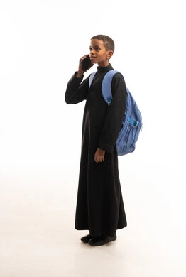 African Saudi Boy in Black Thobe Talking on Phone