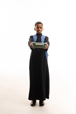 Saudi Schoolboy in Black Thobe Holding Lunchbox